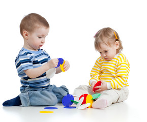 little children playing with colorful toy over white background