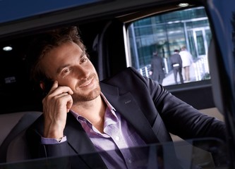 Elegant man in luxury automobile smiling