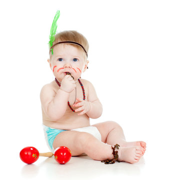 funny baby  as indian  boy with maracas and feather