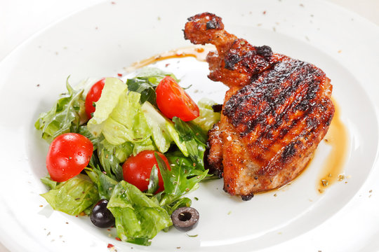 Roasted chicken leg with salad