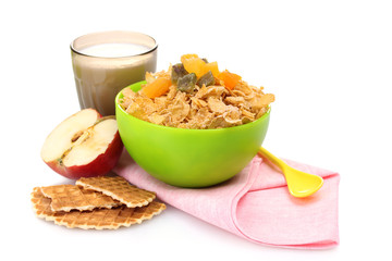 tasty cornflakes in green bowl and glass of milk isolated