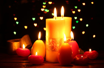 Beautiful candle and decor on wooden table on bright background