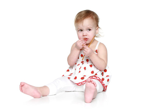 Little girl sitting on floor