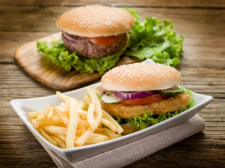 sandwich hamburger with chicken  potatoes and salad