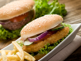sandwich hamburger with chicken  potatoes and salad