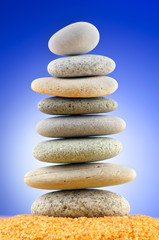 Fototapeta na wymiar Balanced pebbles with colour background