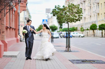 Bride and groom having fun in an old town