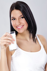 Healthy young woman with glass of milk