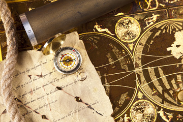 Vintage letter, compass and navigation equipment on map