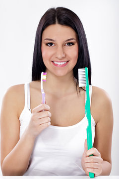 Funny girl with small and big toothbrush