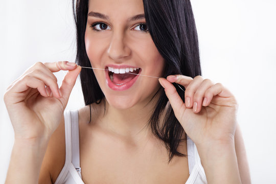 Close up of woman flossing