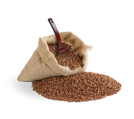 buckwheat in bag with spoon on white background
