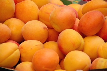 Yellow prunes in a box at the greengrocer on the market
