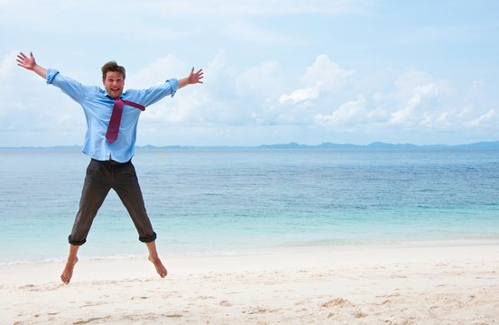 Funny business man jumping on the beach