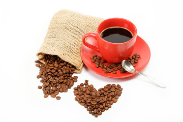 hearts made ​​from coffee beans around a cup of coffee on a