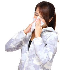 sick woman blowing nose