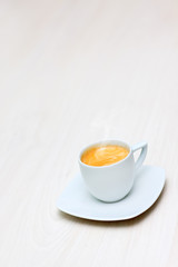 cup of hot coffee on a wooden floor