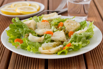 fish salad in the white plate