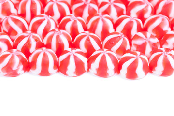 Rows of red and white candy on white background