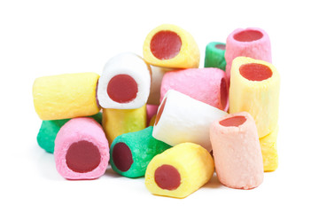 Pile of multicolored candy sticks on white background