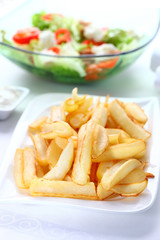 Baked potatoes with dip and vegetable salad