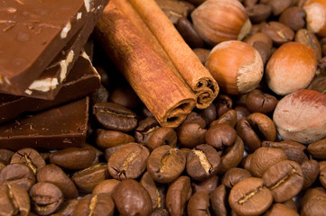 chocolate, coffee beans , cinnamon sticks and hazel