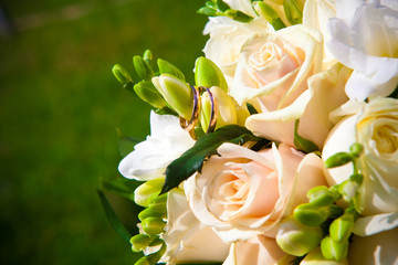 rings on white wedding flowers.
