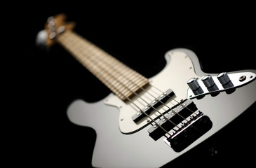 Fototapeta na wymiar close up of a black electric bass glossy on dark background