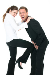 Beautiful woman kicking a businessman