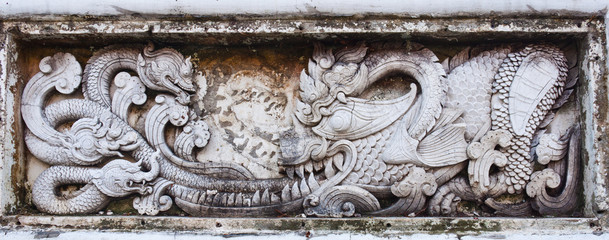 naga statue on wall of fence