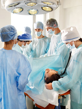 Patient on gurney in operating room.