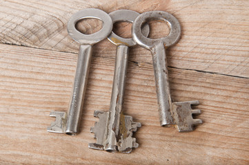 Old keys on a wooden background