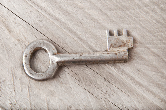 the old key on a wooden background