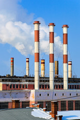 Lots of smoking chimneys other blue sky