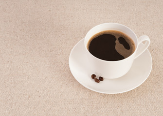 White cup filled with fresh black coffee