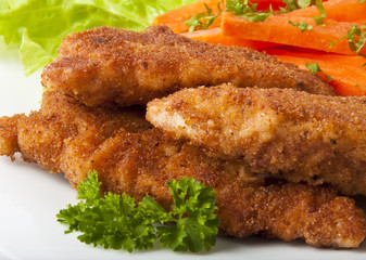 chicken fried in breadcrumbs with vegetables