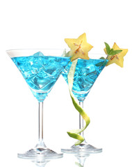 Blue cocktail in martini glasses with ice isolated on white