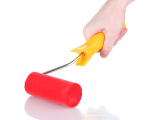 bright paint roller in hand isolated on white
