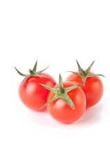 Three red cherry tomatoes on white background
