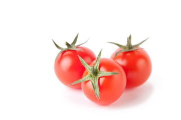 Small red cherry tomatoes, isolated over white