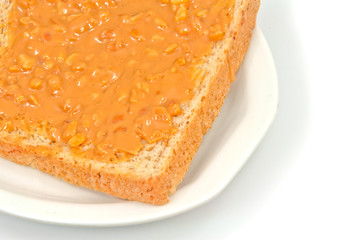 Bread and peanut butter on white background