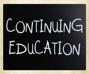 "Continuing Education" handwritten with white chalk on a blackbo