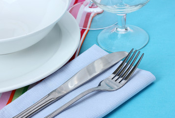 Table setting with fork, knife, plates, and napkin