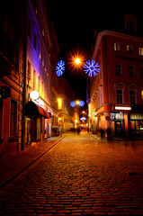 Narrow street in old Riga by night in Christmas time