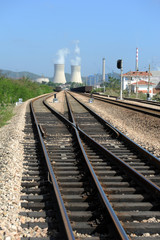 Fototapeta na wymiar Industrial landscape with chimneys and train.