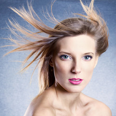 Fashion portrait of beautiful woman with streaming hair