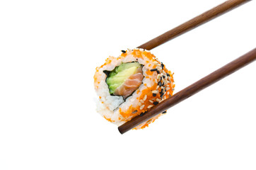Chopsticks holding sushi roll