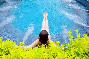 woman sitting in swimming pool