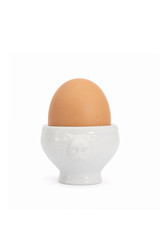 Brown egg in a white cup