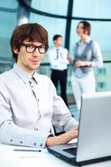 Obraz premium Portrait of business man and his colleagues at the office.